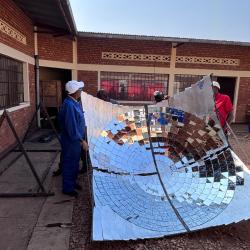 V2SDF training reaches a pivotal phase as educators carefully install the reflective mirrors on the parabolic dish.