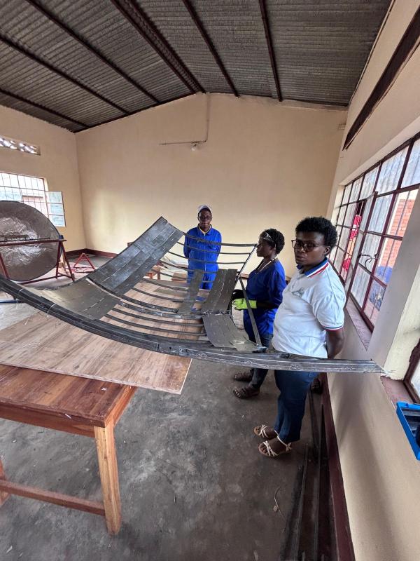 V2SDF training progresses as educators affix the thin support sheeting to the parabolic skeleton of the new model.